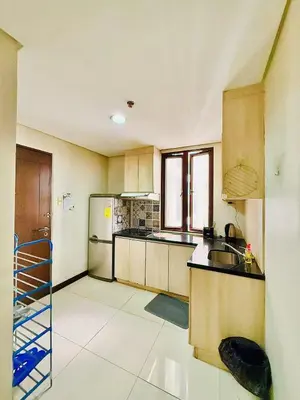 a kitchen with a sink and a refrigerator at Admiral Baysuites 2823 in Manila