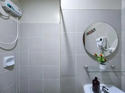 a white bathroom with a mirror and a sink at 1BR Condotel Ridgewood Towers Taguig City #RW16 in Manila
