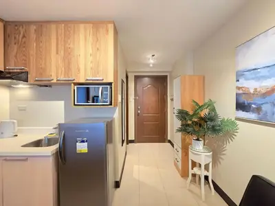 a kitchen with a stainless steel refrigerator and a sink at 1BR Condotel Ridgewood Towers Taguig City #RW16 in Manila