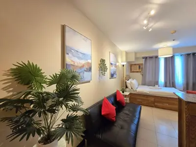 a living room with a couch and a bedroom at 1BR Condotel Ridgewood Towers Taguig City #RW16 in Manila