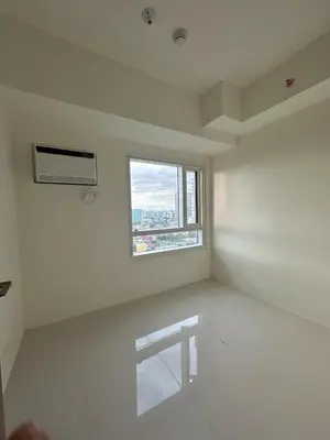a white room with a window and a bench in it at Grand View Tower in Manila