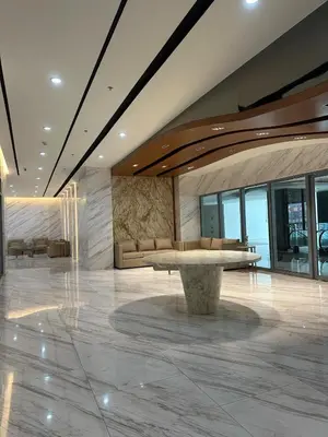 a lobby with a bench in the middle of a building at Grand View Tower in Manila