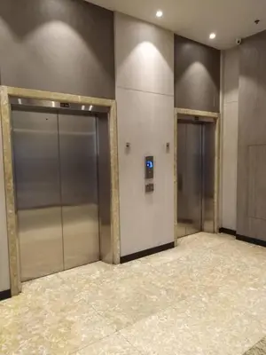 two elevators in a building with their doors open at Araneta Cubao No Brown Outs 1BR Furnished Condo with Balcony free WiFi Netflix in Manila