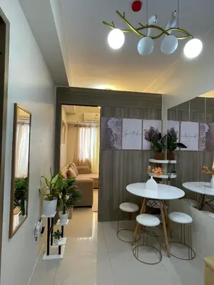 a living room with two tables and a couch at Field Residences King Elite Near NAIA Arport in Manila