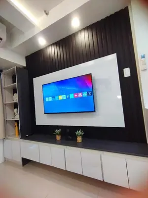 a large screen tv on a wall in a room at Stylish Getaway in the Heart of the City - Mall of Asia in Manila