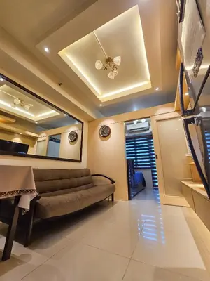 a living room with a couch and a ceiling at Sea Residence in Manila