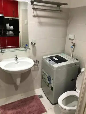 a bathroom with a toilet and a sink at Sea Residence in Manila