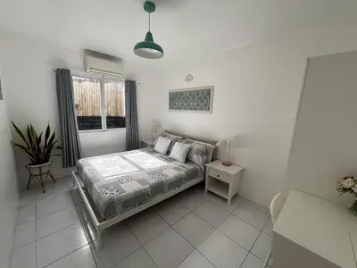 a bedroom with a bed and a window at The Barkly House Staycation in Biñan