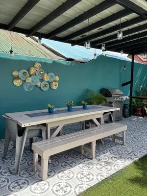 a patio with two benches and a blue wall at The Barkly House Staycation in Biñan