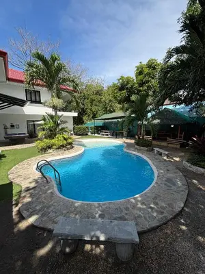 a small swimming pool with a bench next to a building at The Barkly House Staycation in Biñan