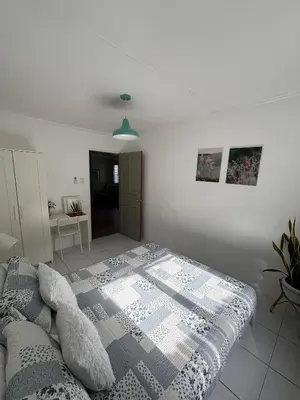 a bedroom with a bed with a blanket on it at The Barkly House Staycation in Biñan