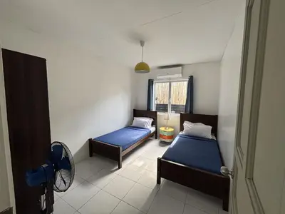 a small room with two beds and a window at The Barkly House Staycation in Biñan