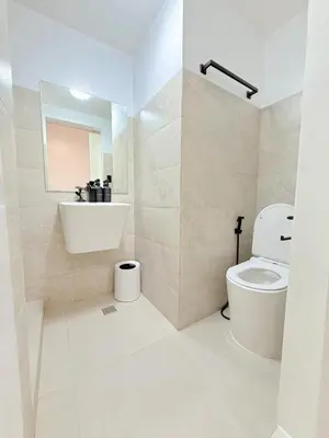 a bathroom with a toilet and a sink at Le Luxe 102 by Ara li in Manila