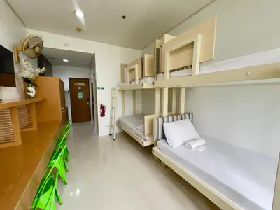 a room with a bed and shelves in it at UPad Taft in Manila