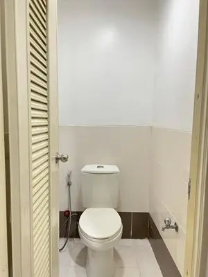 a bathroom with a white toilet in a room at UPad Taft in Manila