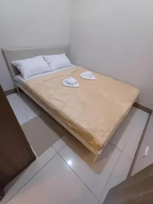 a bed with two towels on it in a room at Cozy and Comfortable 1BedRoom at Coast Residences in Manila