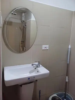a bathroom with a sink and a mirror at Cozy and Comfortable 1BedRoom at Coast Residences in Manila