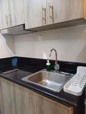 a kitchen with a sink and a counter top at Cozy and Comfortable 1BedRoom at Coast Residences in Manila