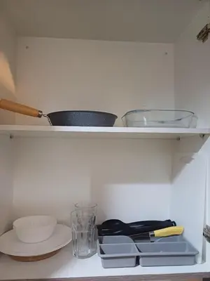 a shelf with bowls and other items on it at Cozy and Comfortable 1BedRoom at Coast Residences in Manila