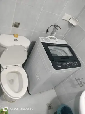 a tv in a bathroom with a toilet at Ederly Place at Sea Residences near Moa in Manila