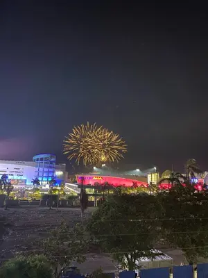 a fireworks display in a city at night at Kim Place at Sea Residences near Moa in Manila