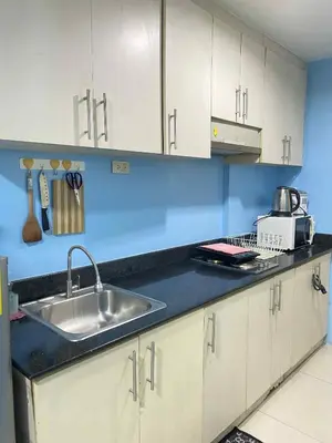 a kitchen with a sink and a counter top at Kim Place at Sea Residences near Moa in Manila
