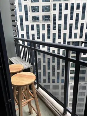 two tables on a balcony with a view of a city at ElixirStaycation at Knightsbridge Residences in Manila
