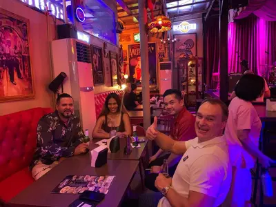 a group of people sitting in a bar at All Access Manila Tour in Manila