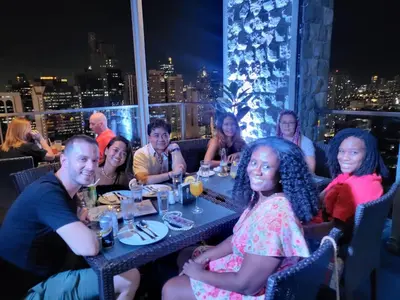 a group of people sitting at a table in a restaurant at All Access Manila Tour in Manila