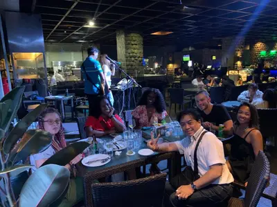 a group of people sitting at a table in a restaurant at All Access Manila Tour in Manila
