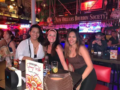 a group of three women sitting at a bar at All Access Manila Tour in Manila