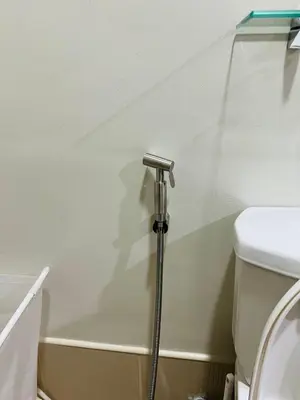 a bathroom with a toilet and a shower stall at 1BR luxury bed, movie room, swimming pool access in Manila