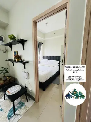 a bedroom with a bed and a mirror in a room at 1BR luxury bed, movie room, swimming pool access in Manila