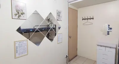 a room with a wall with a mirror on it at Affordable Fully Furnished Place in the City in Manila