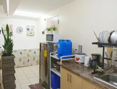 a kitchen with a sink and a refrigerator at Affordable Fully Furnished Place in the City in Manila