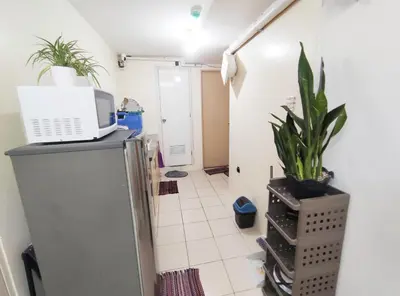 a kitchen with a microwave on top of a refrigerator at Affordable Fully Furnished Place in the City in Manila