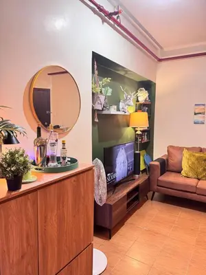 a living room with a couch and a mirror at Urban Escape for You & Your Pet in Manila
