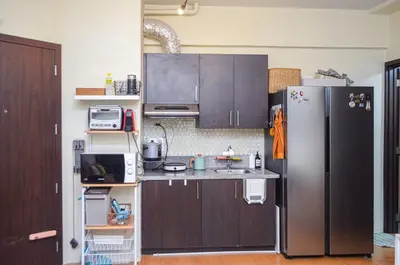 a kitchen with a stainless steel refrigerator at Urban Escape for You & Your Pet in Manila