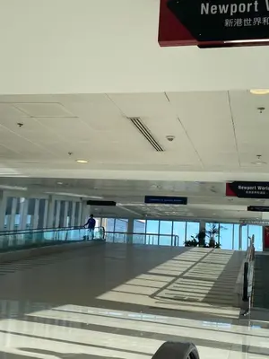 an airport baggage claim area with a person walking around at studio flat at 101 Newport Boulevard in Manila