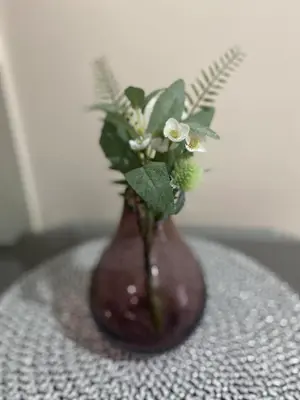 a brown vase with flowers in it on a table at studio flat at 101 Newport Boulevard in Manila