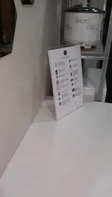a box sitting on a shelf next to a refrigerator at studio flat at 101 Newport Boulevard in Manila