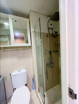 a bathroom with a toilet and a glass shower at Shell Residence Tower A 250A in Manila