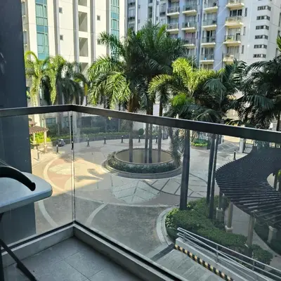 a balcony with a view of a courtyard with palm trees at LDN Secret Crib -Two palm tree across NAIA Terminal 3 in Manila