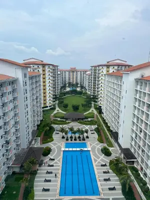 an overhead view of a swimming pool in a resort at 2BR Family suite with Balcony with WiFi and Netflix, behind SM Sucat in Manila