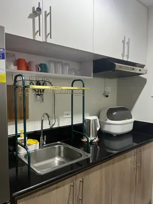 a kitchen with a sink and a counter top at 2BR Family suite with Balcony with WiFi and Netflix, behind SM Sucat in Manila