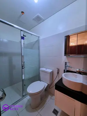 a bathroom with a toilet and a shower and a sink at 2BR with 2 balconies condo and Pool in Pasig in Manila