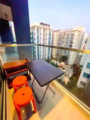 a balcony with a table and two chairs on a balcony at NAIA T3 Two Palmtree Villas 3-5mins away from Resorts World Casino Manila in Manila