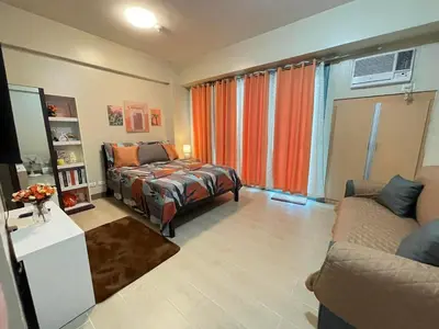 a living room with a bed and a couch at NAIA T3 Two Palmtree Villas 3-5mins away from Resorts World Casino Manila in Manila