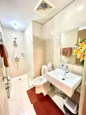 a bathroom with a sink and a toilet and a shower at NAIA T3 Two Palmtree Villas 3-5mins away from Resorts World Casino Manila in Manila