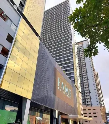 a large building with a sign in front of it at fame residence staycation in Manila
